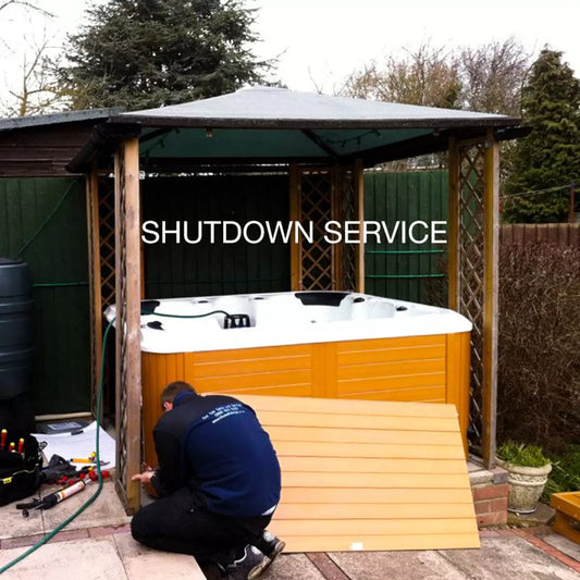 A certified technician performing a deep chemical clean and vacuum extraction on an empty Blue Whale Spa hot tub during a professional winter shutdown service.