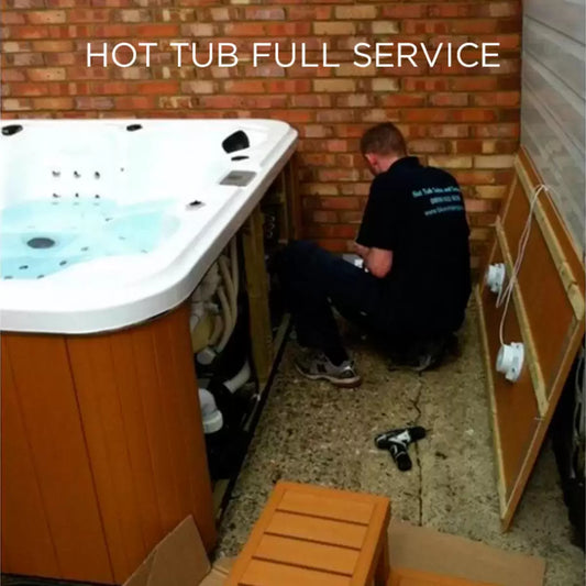 A technician conducting a comprehensive internal inspection and pipework flush on a Blue Whale Spa hot tub during a professional annual service visit.