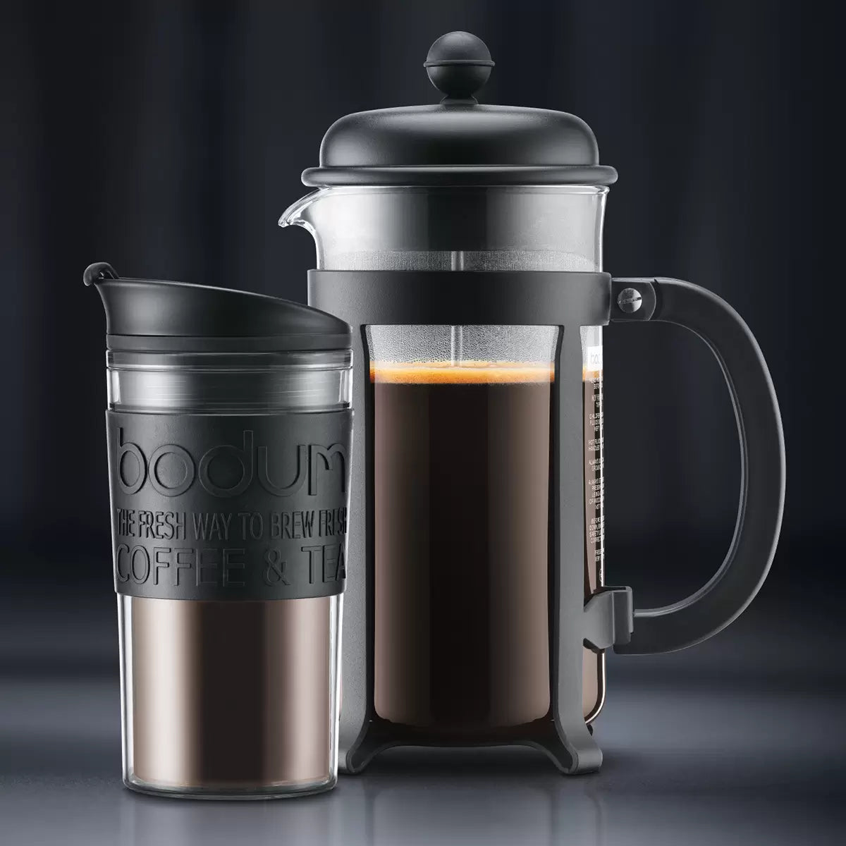 Close up of the Bodum Java coffee press plunger and heat-resistant travel mug held by a person.