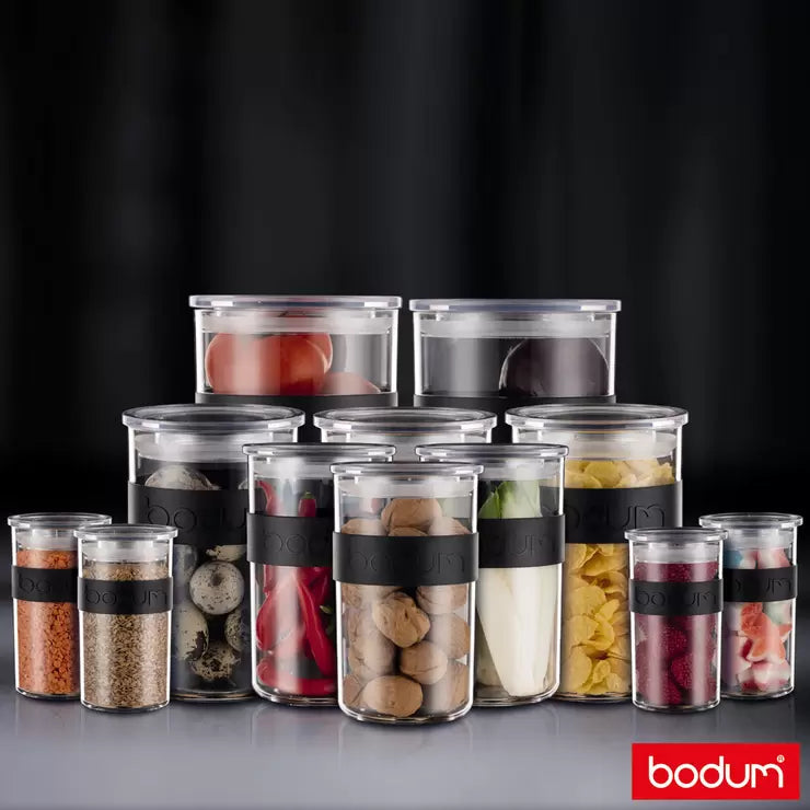 Full set of 12 Bodum PRESSO storage jars displayed on a modern kitchen shelf showing various sizes.