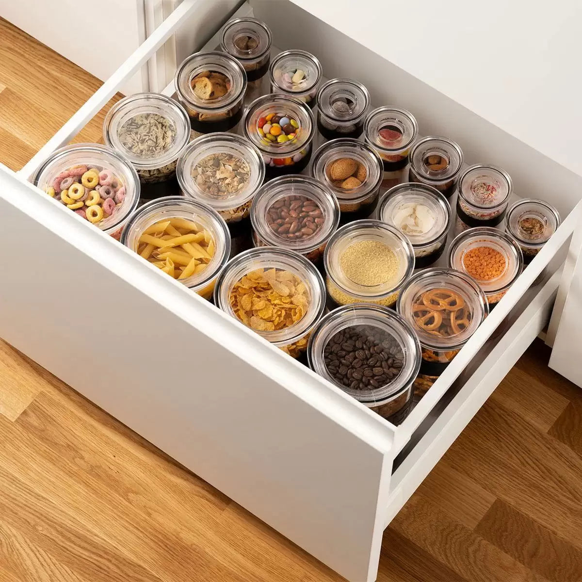Full set of 12 Bodum PRESSO storage jars displayed on a modern kitchen shelf showing various sizes.