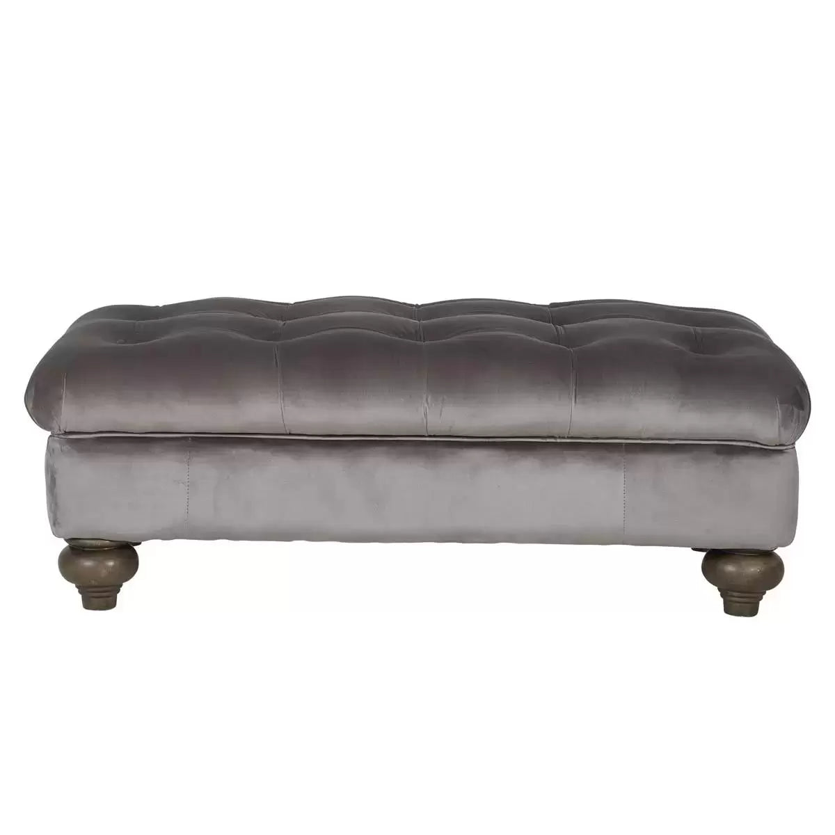 Front angle view of the Bordeaux Grey Velvet Footstool featuring deep hand-tied tufting and dark stained solid wood legs in a modern living room setting.