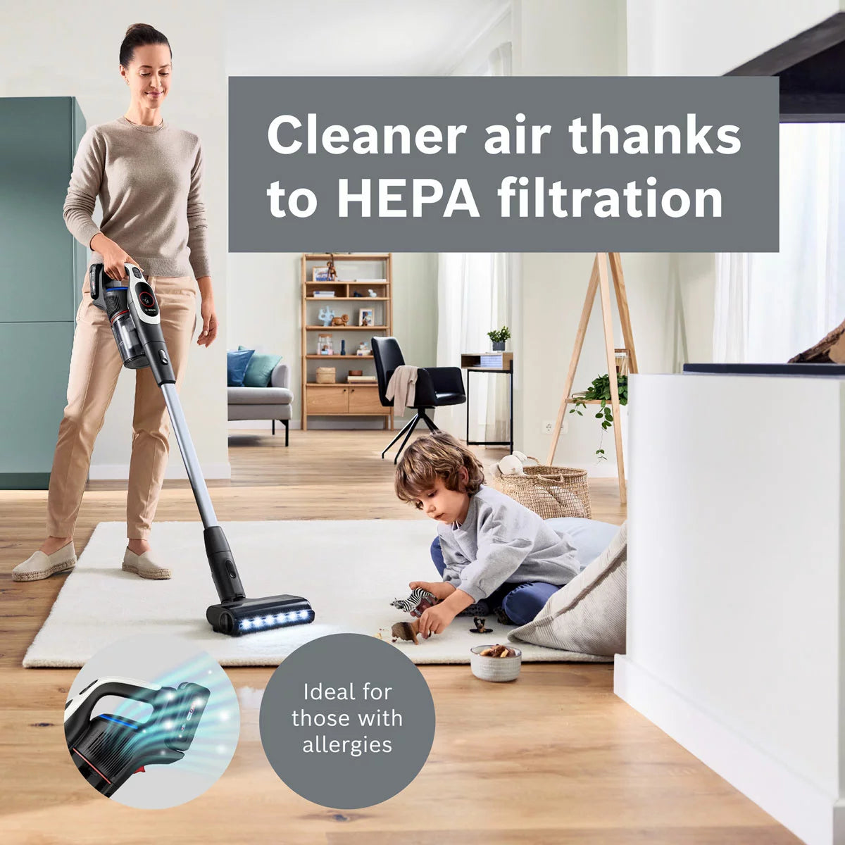 Front view of the sleek white Bosch BBS931WGB Unlimited 9 cordless vacuum cleaner standing upright on grey tile flooring with its blue MicroClean LED indicator glowing.