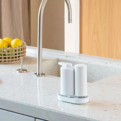Brabantia SinkStyle soap dispenser set in two colour options displayed on a clean kitchen countertop.