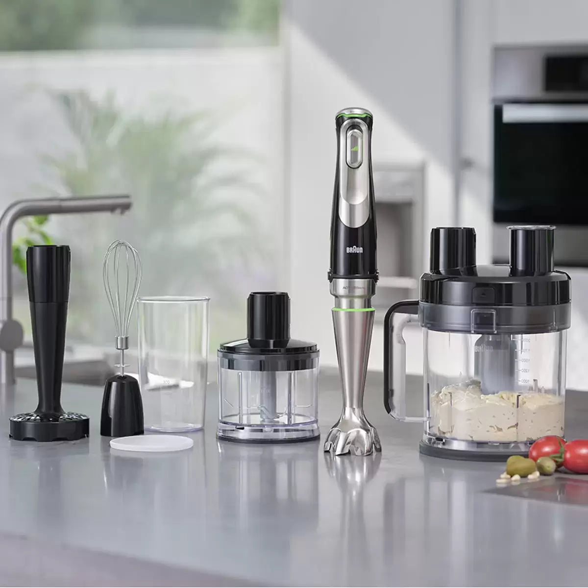 The Braun MultiQuick 9 MQ9187XLI hand blender base shown with its full array of professional-grade attachments, including the 2L food processor and stainless steel whisk on a clean kitchen surface.