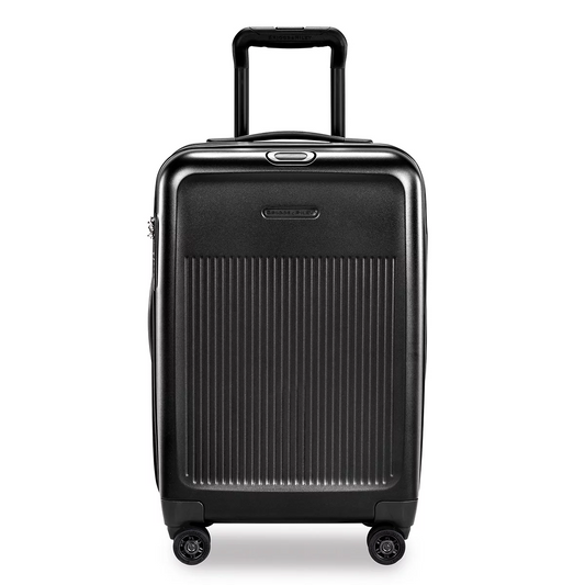 Front studio angle of the glossy Briggs & Riley Sympatico Domestic Carry-On Expandable Spinner Case showing the telescoping aluminium handle, TSA lock, and dual spinner wheels.