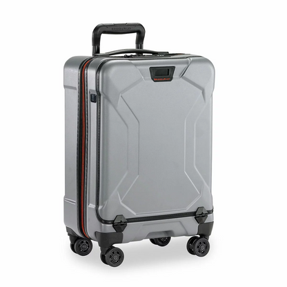 Sleek graphite grey Briggs & Riley Torq 53cm carry-on spinner suitcase showing its open hinged front pocket with a laptop inserted inside.