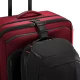 Three-quarter angle view of the black Briggs & Riley ZDX 66cm Medium Expandable Spinner Suitcase highlighting its exterior handle, zip expansion, and smooth dual spinner wheels on a neutral background.