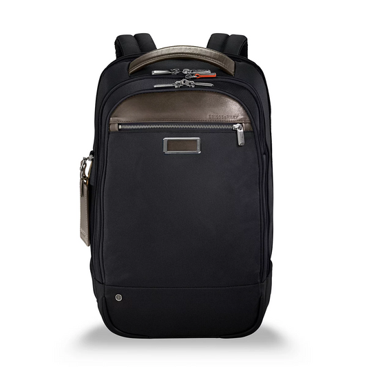 Black Briggs & Riley @work Medium Backpack with structured ballistic nylon finish standing upright, showcasing side zippers and top padded handle.