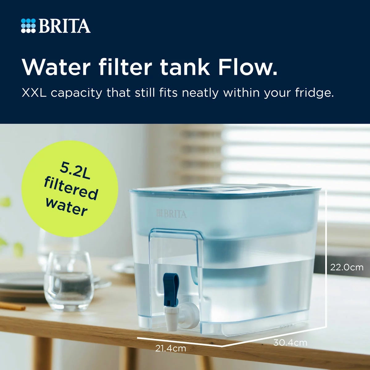 Transparent blue-tinted Brita Flow XXL 8.2L water filter tank with dispensing tap shown resting on a modern kitchen countertop.