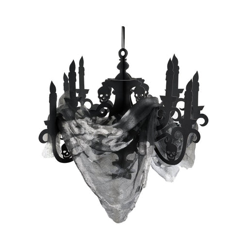 Black cardboard candelabra decoration with draped black gauze fabric hanging against a dark Halloween party background.