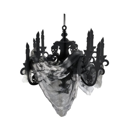 Black cardboard candelabra decoration with draped black gauze fabric hanging against a dark Halloween party background.
