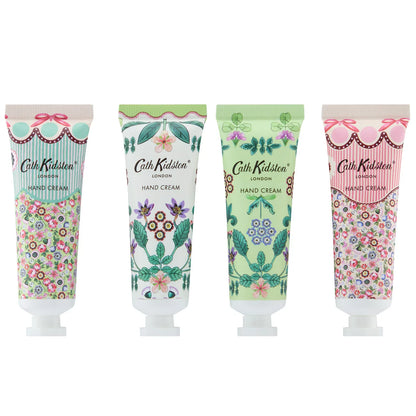 Flat lay arrangement of eight colorful Cath Kidston 30ml hand cream tubes featuring hand-painted flower patterns around an opened gift box.