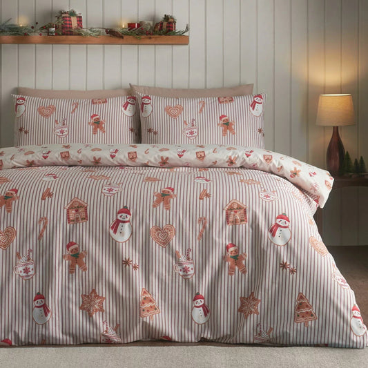 Catherine Lansfield Christmas gingerbread stripe reversible duvet cover set with matching pillowcases laid on a styled bed.