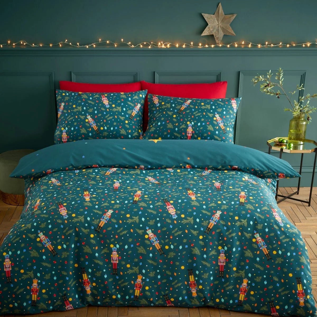 Catherine Lansfield Christmas nutcracker duvet cover set in deep green styled neatly on a bed with matching pillowcases.
