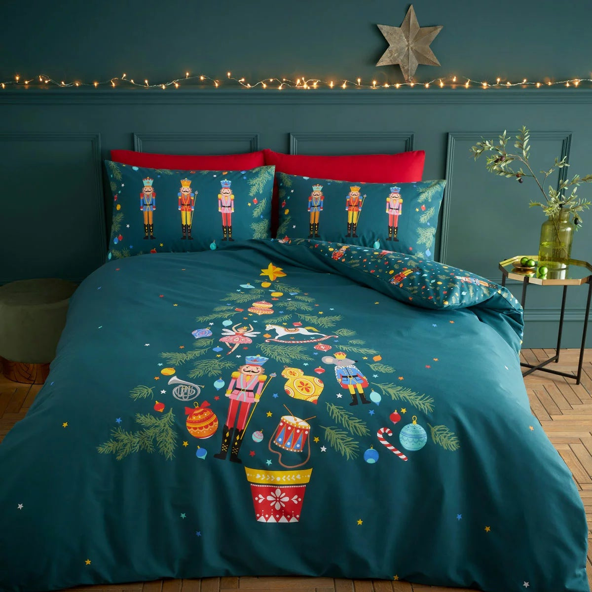 Catherine Lansfield Christmas nutcracker duvet cover set in deep green styled neatly on a bed with matching pillowcases.