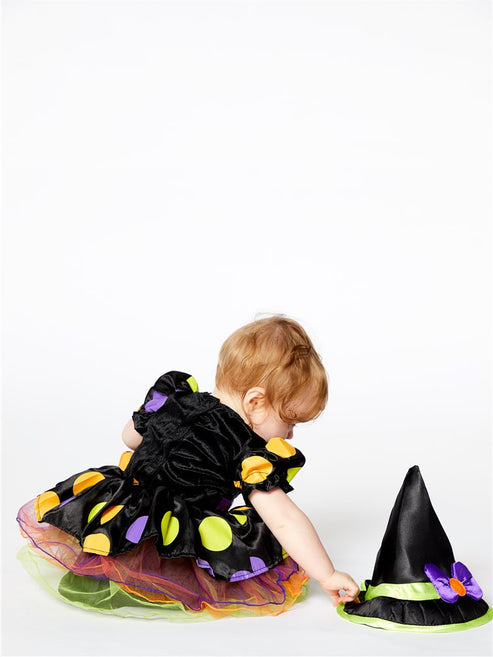 Front view of the Cauldron Cutie baby witch costume featuring a dotty polka-dot dress, colorful tulle skirt, and matching pointed witch hat with a purple bow.