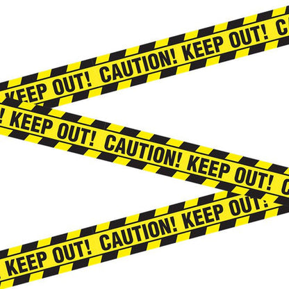 Bright yellow plastic caution tape stretched taut across a dark wooden doorway for party decoration.