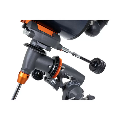 Profile shot of the metallic blue Celestron 90EQ Astromaster Maksutov-Cassegrain telescope mounted on its steel equatorial tripod, positioned against a clean minimalist studio backdrop.