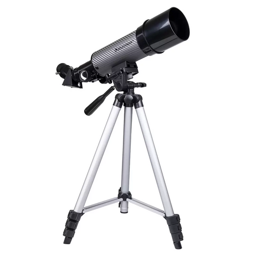 Side view of the compact black and silver Celestron Travel Scope 60DX telescope mounted on its aluminum tripod, with its custom padded travel backpack sitting open alongside it.