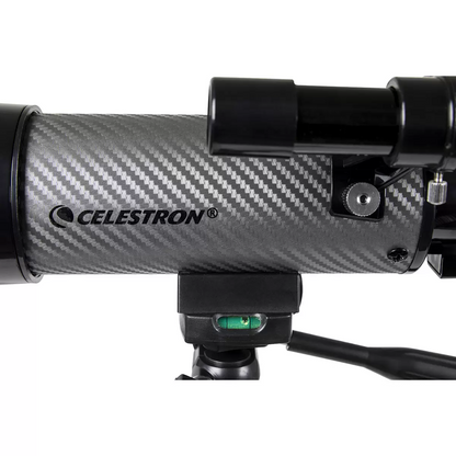 Side view of the compact black and silver Celestron Travel Scope 60DX telescope mounted on its aluminum tripod, with its custom padded travel backpack sitting open alongside it.