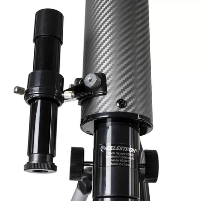 Side view of the compact black and silver Celestron Travel Scope 60DX telescope mounted on its aluminum tripod, with its custom padded travel backpack sitting open alongside it.