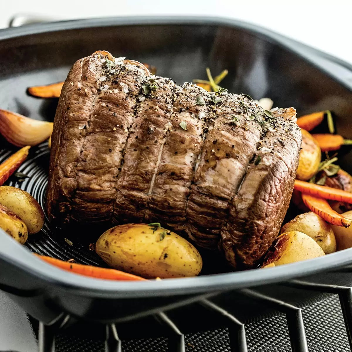 Circulon Ultimum 4-piece professional roasting and baking set laid out on a marble kitchen counter.