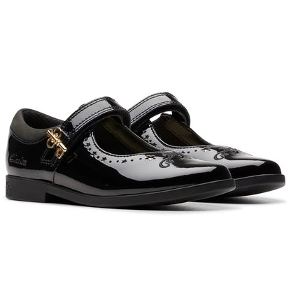 Front angle view of black patent leather Clarks Kids Lock Magic school shoes with riptape strap and key detail design on a neutral studio background.