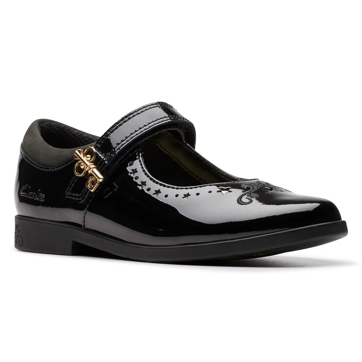 Front angle view of black patent leather Clarks Kids Lock Magic school shoes with riptape strap and key detail design on a neutral studio background.