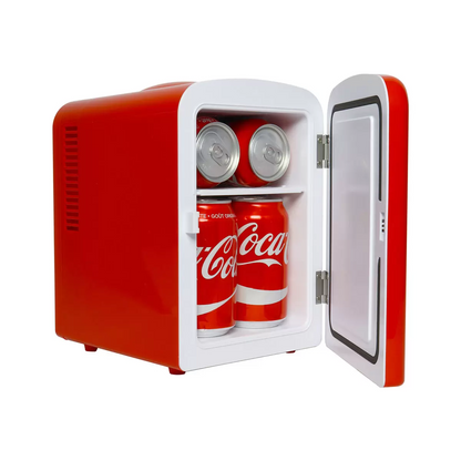 Front view of the vibrant red vintage Coca-Cola 4L mini fridge with retro latch handle, sitting on a modern wooden desk next to a smartphone.