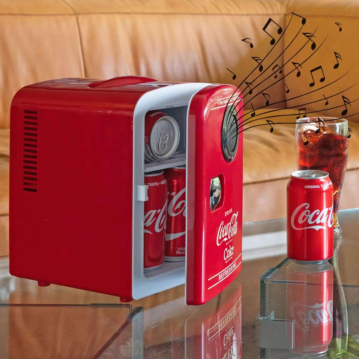 Front view of the vibrant red vintage Coca-Cola 4L mini fridge with retro latch handle, sitting on a modern wooden desk next to a smartphone.