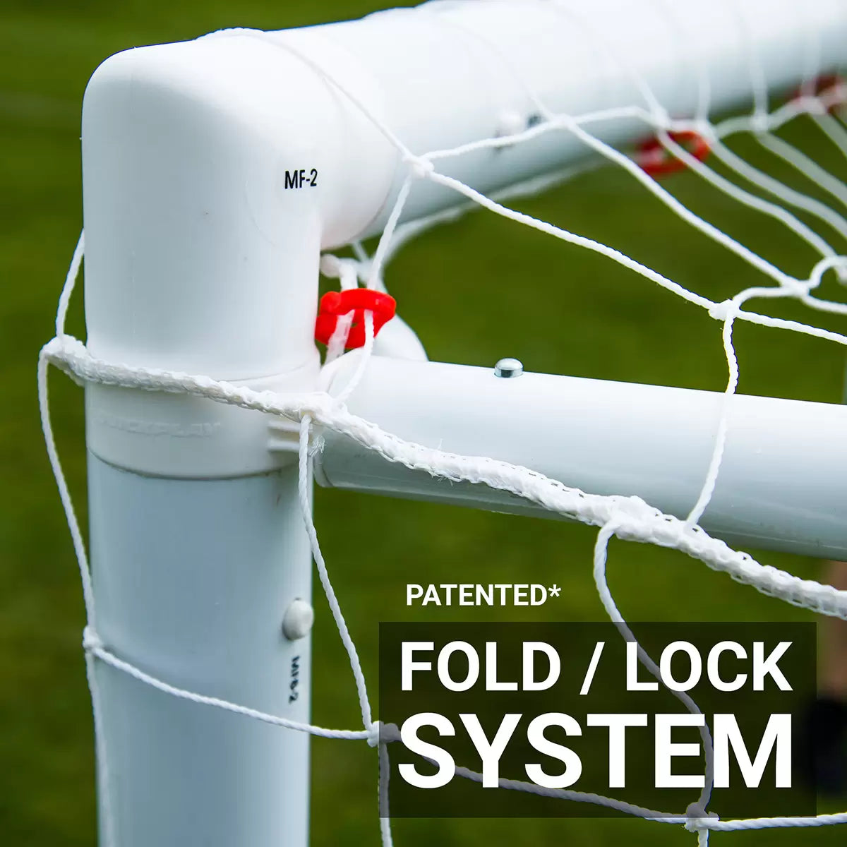 Front angle view of the white Quickplay Q-Fold 6x4 football goal standing secure on a green turf field with its net fully tensioned.