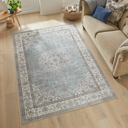 Top-down view of the Concept Looms Liberty Blue Washable Rug showcasing its rich blue vintage pattern and velvet short-pile texture on light hardwood flooring.