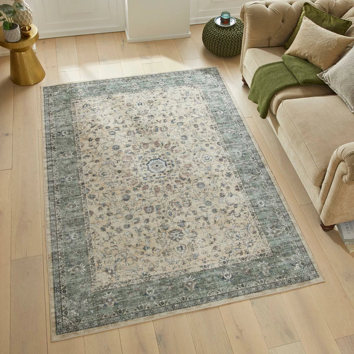 Angle view of the cream and green floral Concept Looms Liberty Washable Rug showing its plush velvet texture and short 4mm pile on a dark laminate floor.