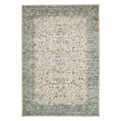 Angle view of the cream and green floral Concept Looms Liberty Washable Rug showing its plush velvet texture and short 4mm pile on a dark laminate floor.
