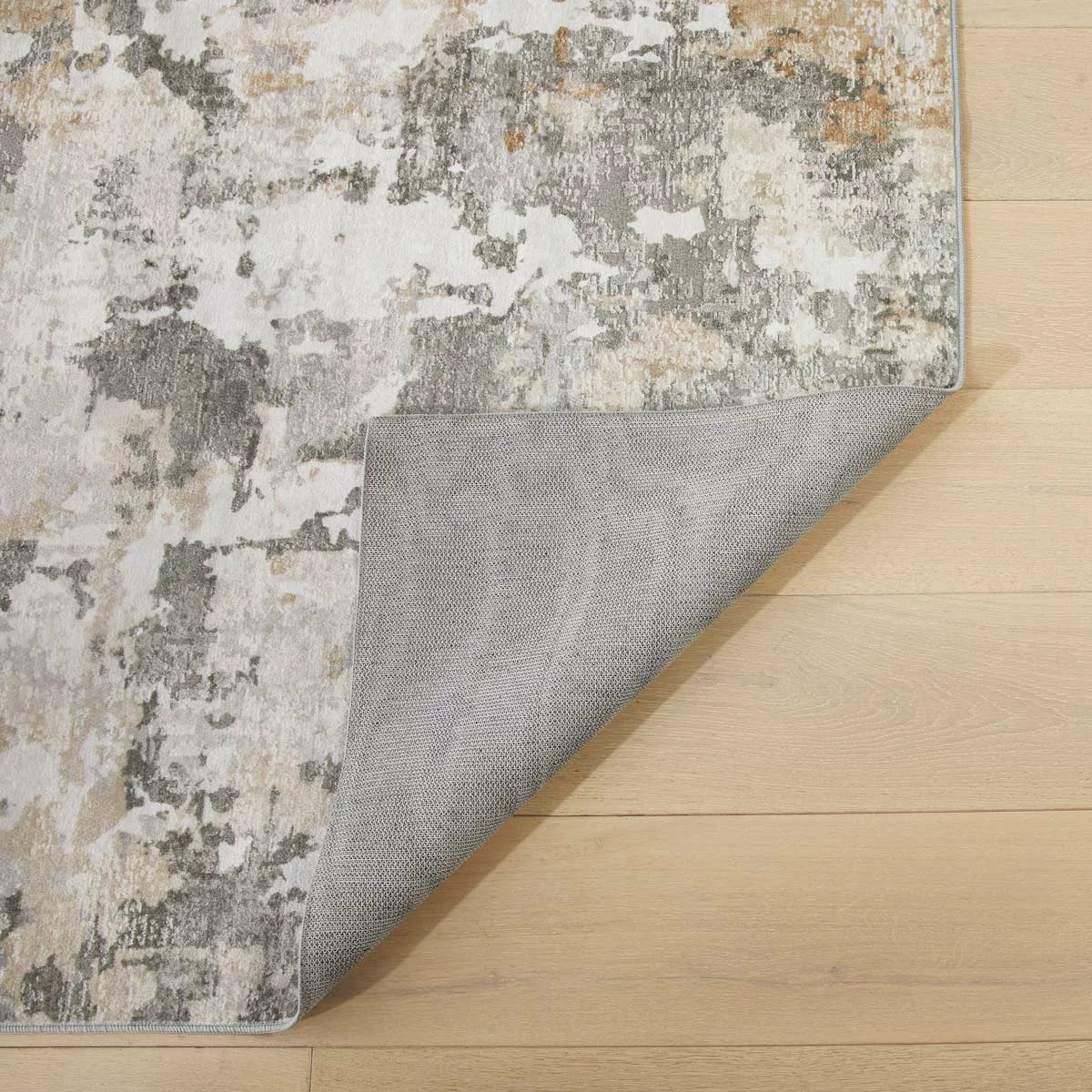 Flat-lay angle of the gray Concept Looms Liberty Quarry Washable Rug showing its smooth short-pile velvet surface and non-slip backing on light flooring.