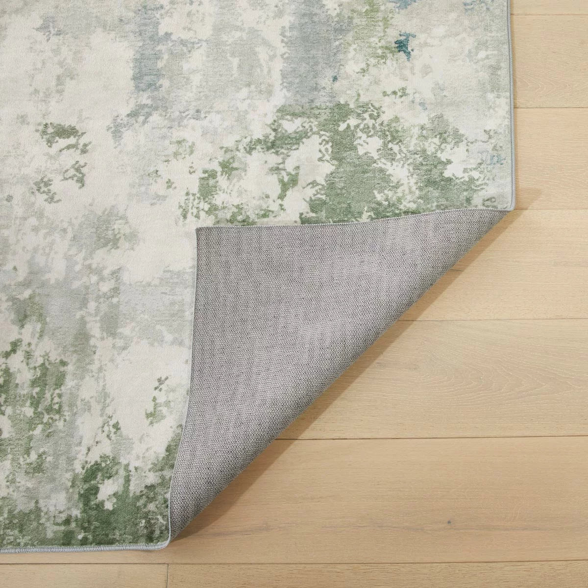 Flat-lay top view of the soft seafoam velvet texture and short 4mm pile on the Concept Looms Liberty Seafoam Washable Rug.