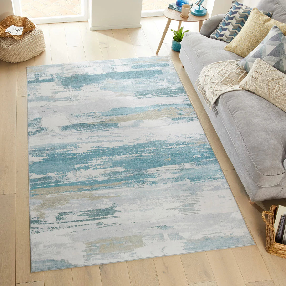 Concept Looms Liberty Sky Washable Rug 120x180cm featuring a smooth sky-blue velvet surface and non-slip backing laid on light wood flooring.