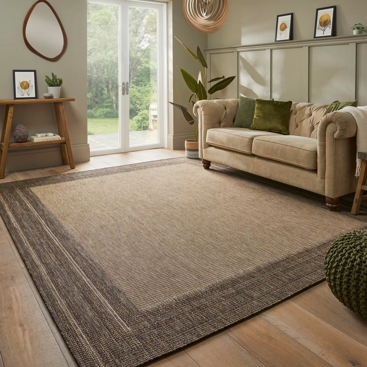 Concept Looms Sumac beige and brown textured flatweave rug styled on a sunny outdoor patio floor.