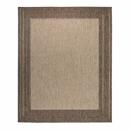 Concept Looms Sumac beige and brown textured flatweave rug styled on a sunny outdoor patio floor.