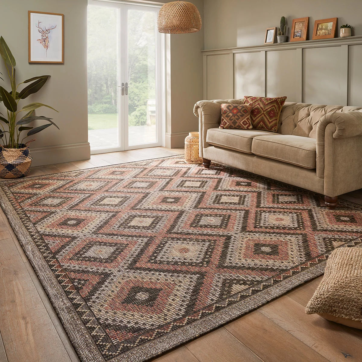 Concept Looms Sumac flatweave rug featuring warm brown and rust geometric patterns displayed on a outdoor wooden deck.