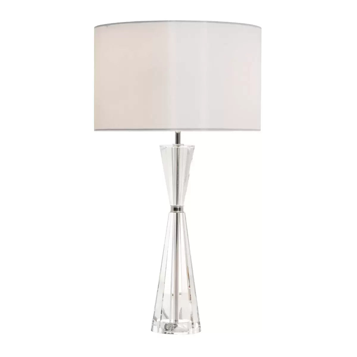 Luxurious Risha table lamp featuring a heavy, faceted hourglass-shaped crystal base, polished nickel hardware, and an elegant ivory faux silk drum shade styled in a contemporary living room interior.