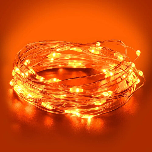 Dalugo 3-metre orange fairy light strand with 30 amber LEDs wrapped neatly around a rustic wooden mantelpiece display.