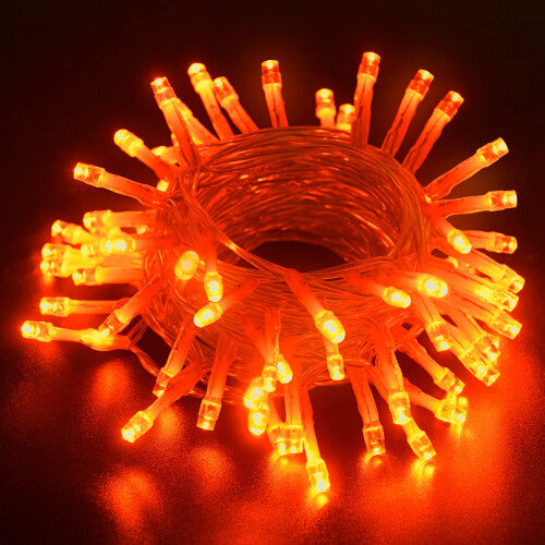 Dalugo 10ft orange battery-operated fairy lights with 30 micro LEDs wrapped tightly around an autumn pumpkin wreath on a wooden display.