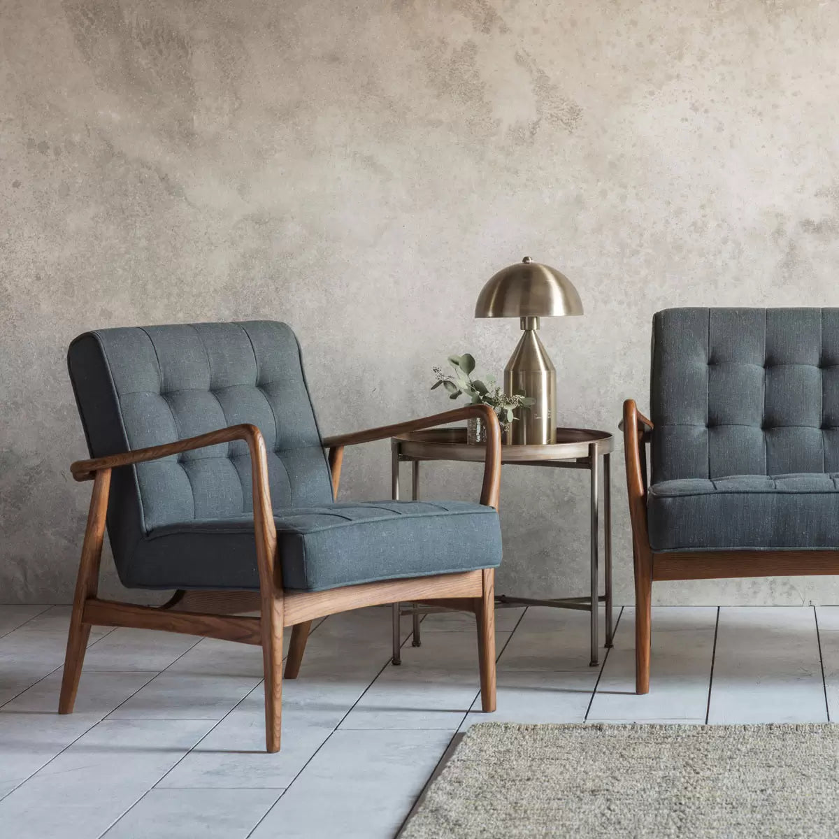 Dark grey linen armchair with wooden frame and deep cushioned seat designed for modern living room comfort