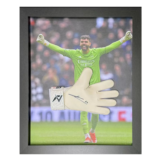A professionally framed, match-grade Arsenal goalkeeper glove signed by David Raya, displayed against a dark backdrop to emphasize texture and detail.