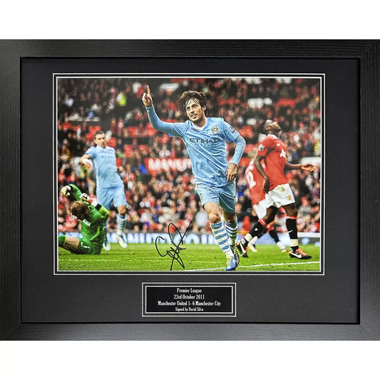 A framed, hand-signed action photograph of David Silva scoring during the 6-1 Manchester City derby victory, featuring a professional dark-finish frame.