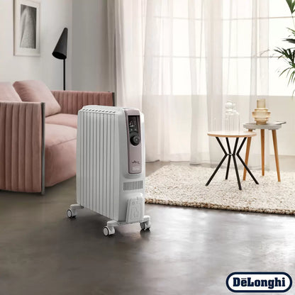 Front angle view of the white De'Longhi Dragon 4 oil filled radiator showcasing its digital LED control panel, enlarged convective fins, and pre-assembled wheels on a wooden floor setting.