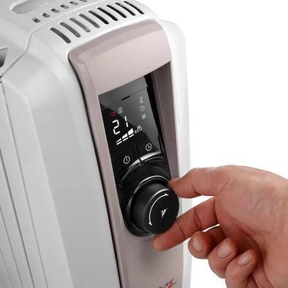 Front angle view of the white De'Longhi Dragon 4 oil filled radiator showcasing its digital LED control panel, enlarged convective fins, and pre-assembled wheels on a wooden floor setting.