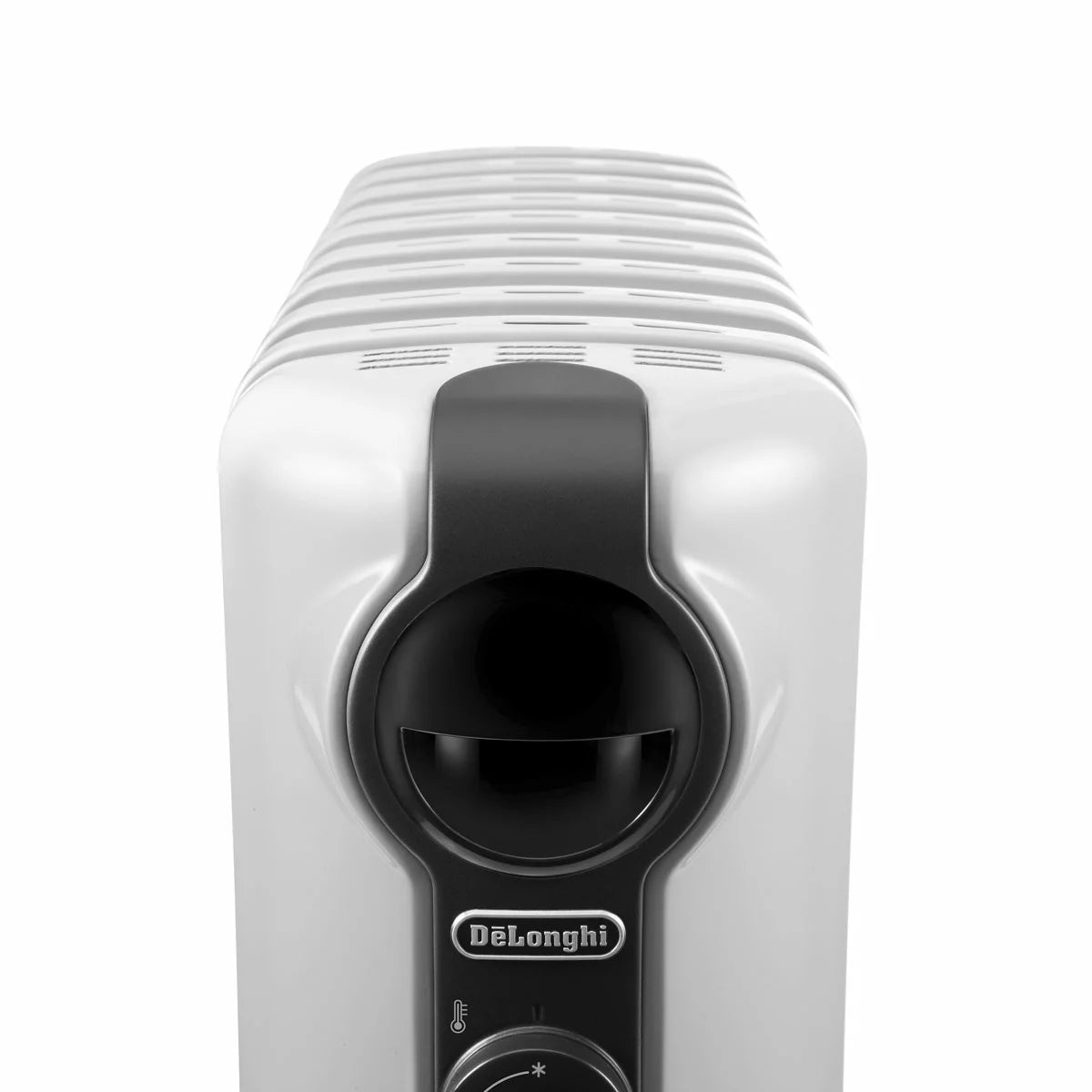 White De'Longhi Radia S 1.5kW oil filled radiator standing on a wooden floor in a modern living room setting showing pre-assembled castors and control knobs.